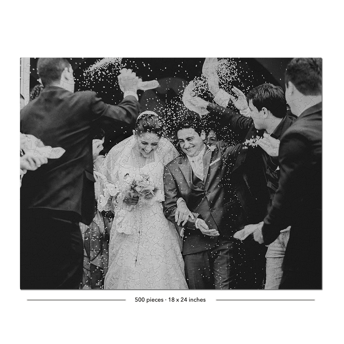 Black and white wedding photograph showing a bride in a lace gown and groom in a suit being showered with confetti, surrounded by guests throwing paper bags. The photo is framed with a black border and small text at the bottom reading '200 places - 15 x 24 inches'.