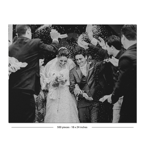 Black and white wedding photograph showing a bride in a lace gown and groom in a suit being showered with confetti, surrounded by guests throwing paper bags. The photo is framed with a black border and small text at the bottom reading '200 places - 15 x 24 inches'.