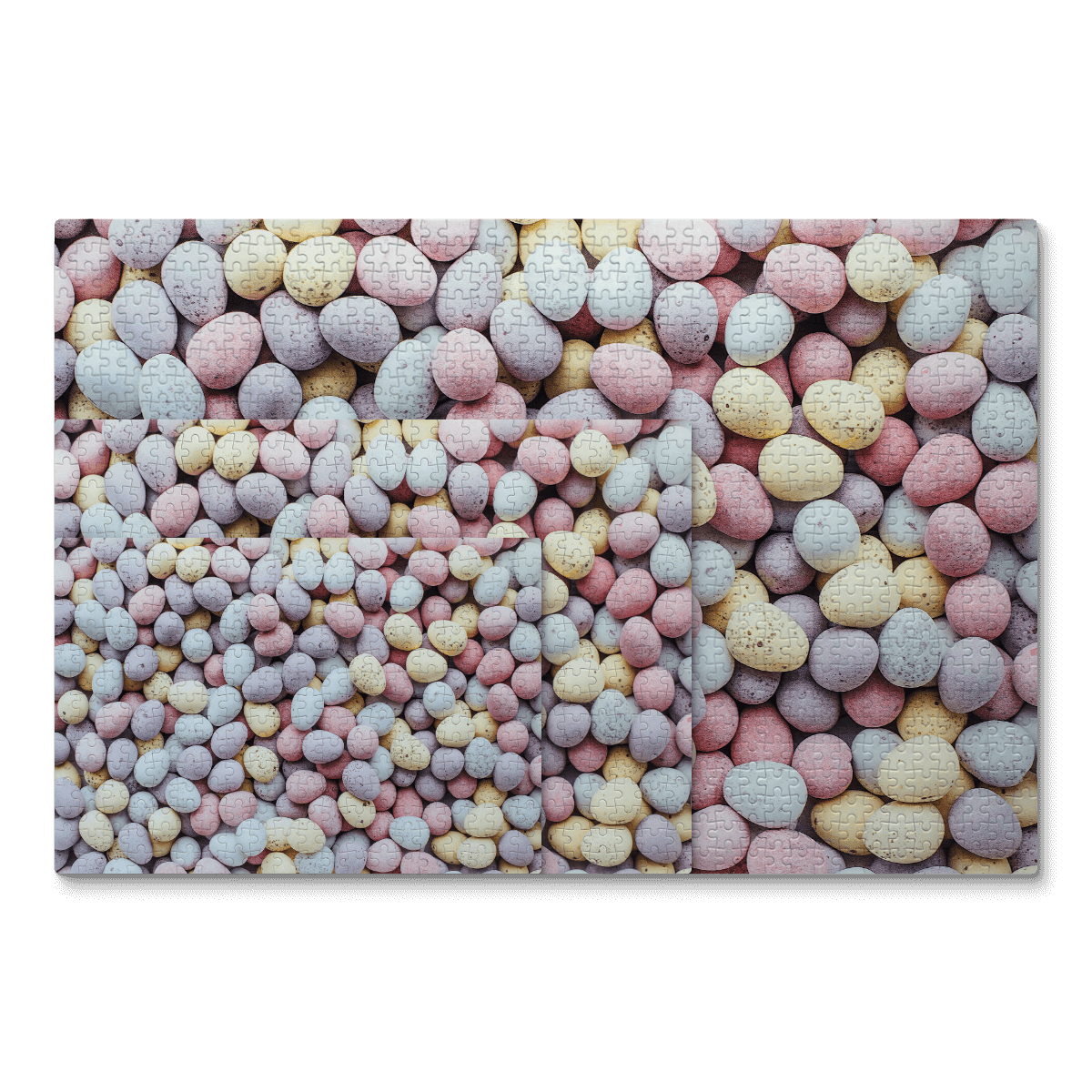 Jigsaw puzzles overlap, showcasing a photo of chocolate eggs in soft pastel shades.