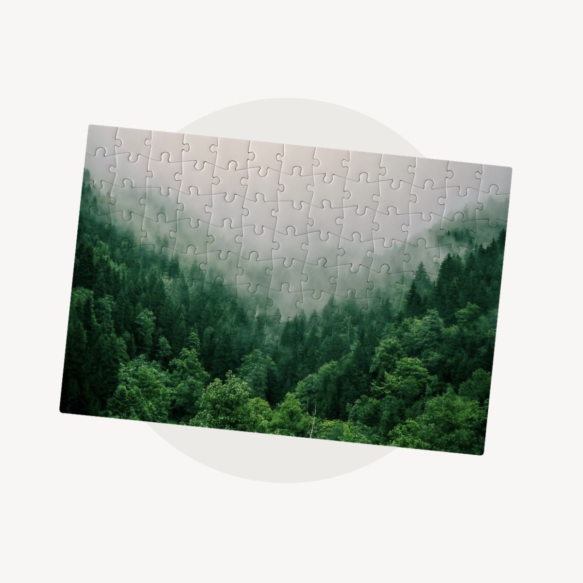 A small jigsaw puzzle with a foggy forest printed on it