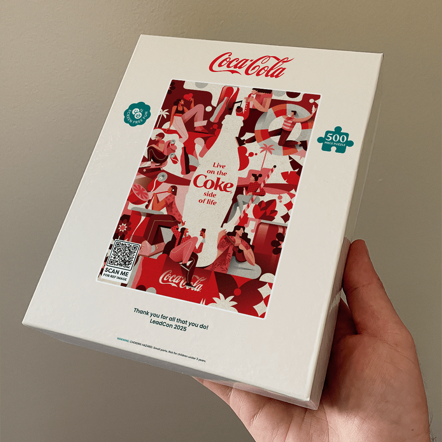 A puzzery puzzle box with a custom logo held by a hand with a neutral background