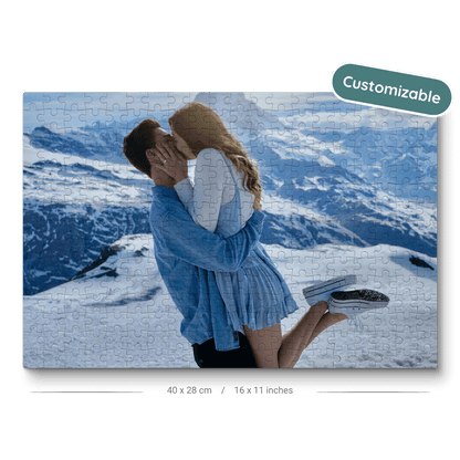 A puzzle of a couple kissing on top of a snowy mountain with a label of customizable overlayed