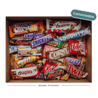 A cardboard box filled with assorted candy bars shown on a black background with a teal 'Customizable' badge in the top right.