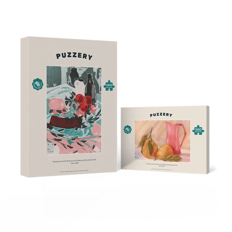 Two Puzzery puzzle boxes with artistic illustrations on a white background
