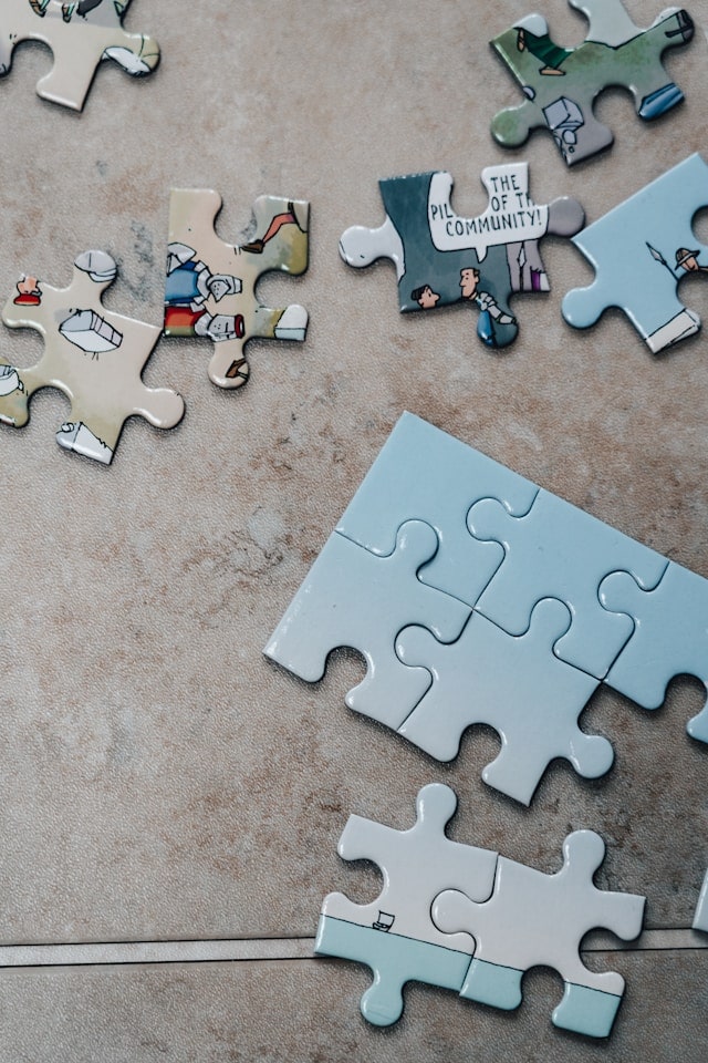 Puzzle pieces on a textured tile surface